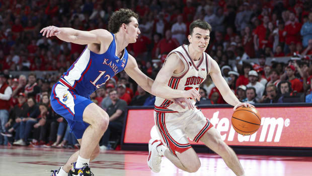 Mar 9, 2024; Houston, Texas, USA; Houston Cougars guard Ryan Elvin (20) controls the ball as Kansas Jayhawks guard Wilder Evers (12) defends during the second half at Fertitta Center. 